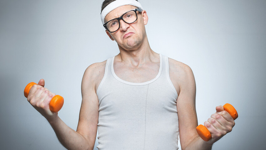 Facial expression nerd with dumbbells